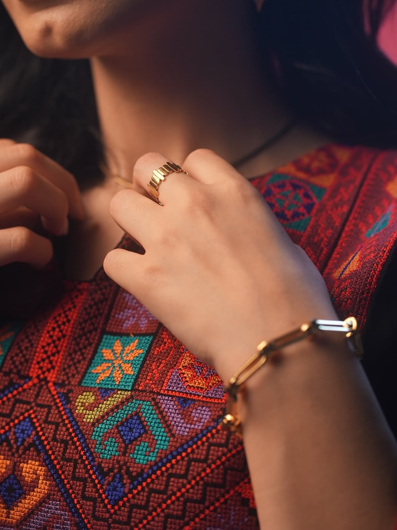 Close embroidery and jewelry detail from the Jadra collaboration