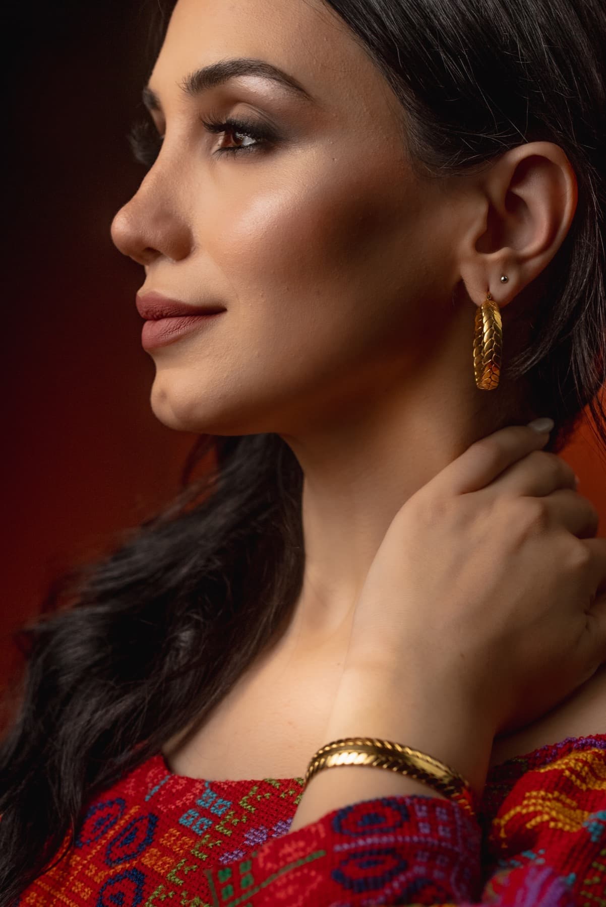 Close portrait with gold earring from the Jadra collaboration