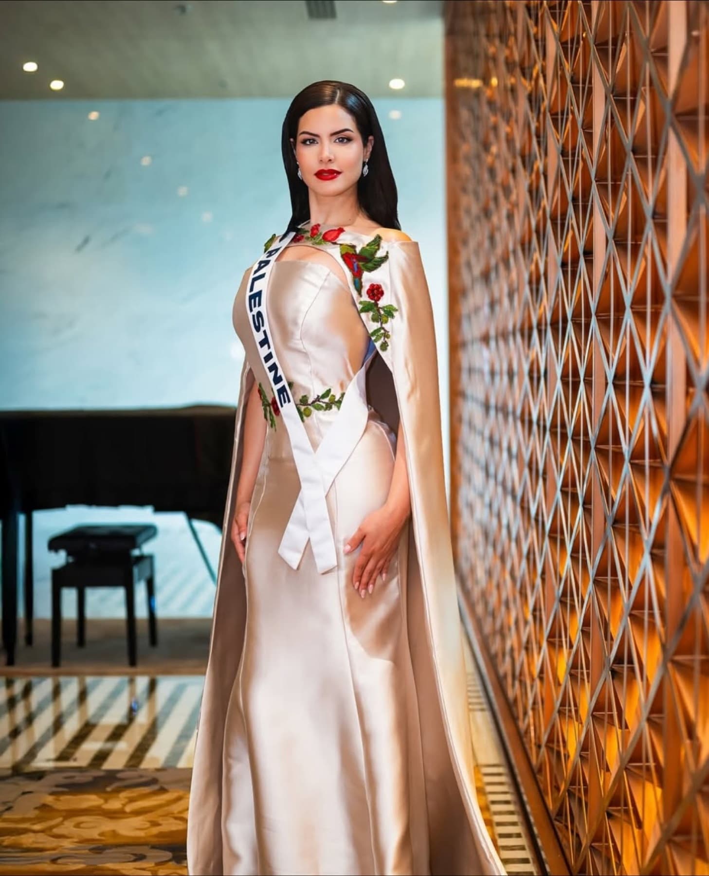Nadeen Ayoub wearing the Miss Palestine cape and sash