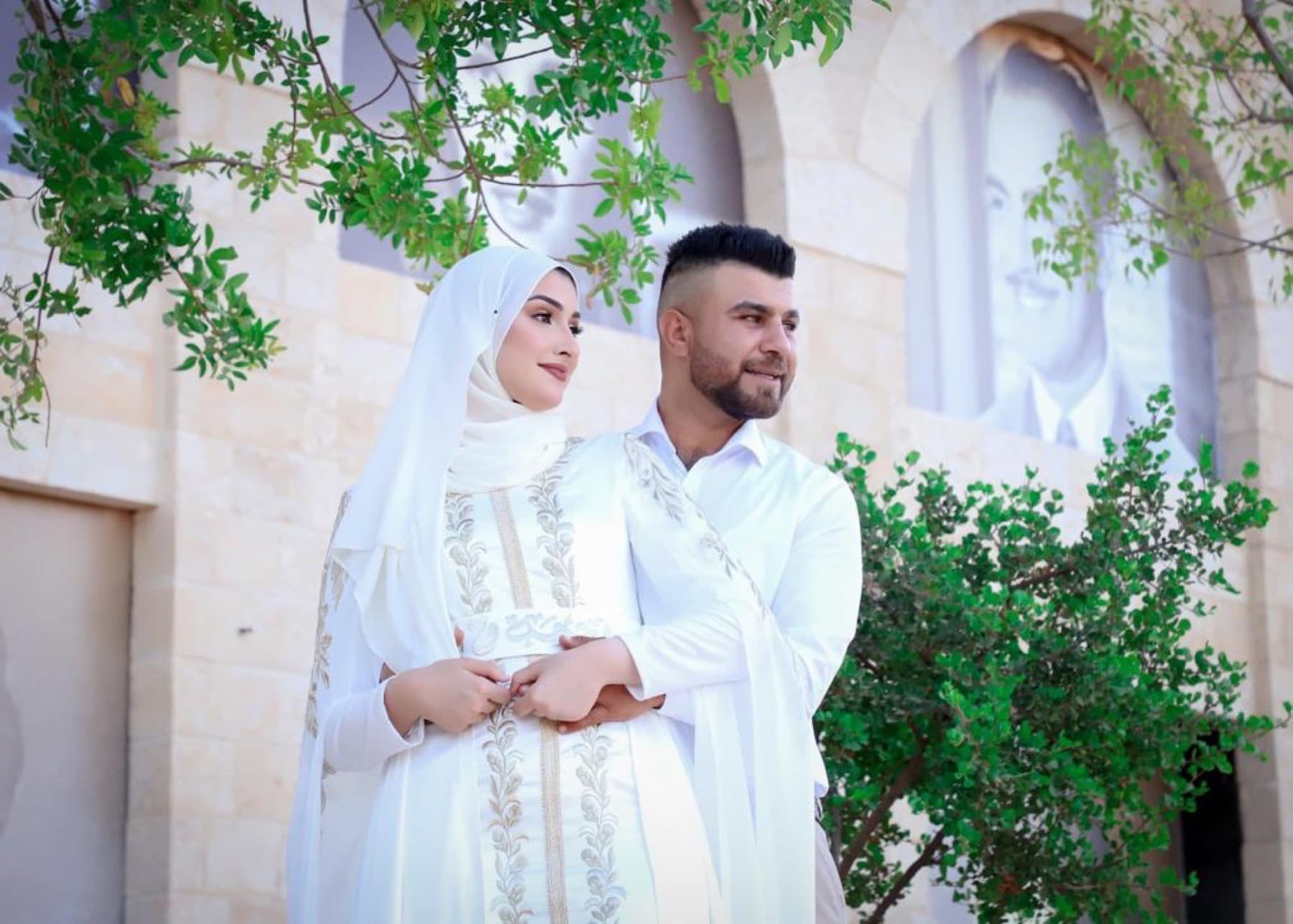 Bride and groom in embroidered white ceremonial garments