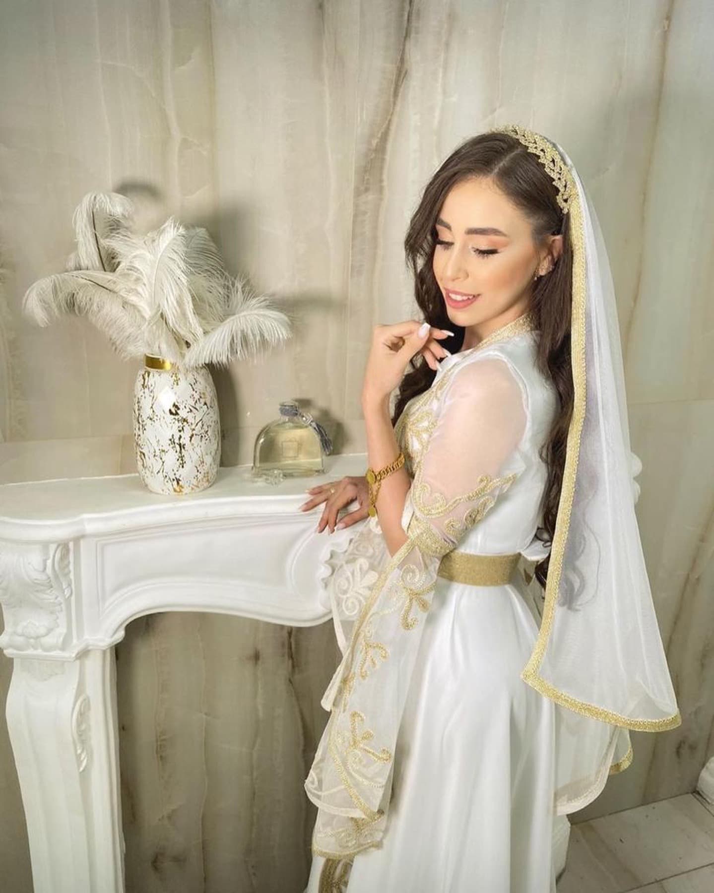 Bride wearing an embroidered veil and gold details