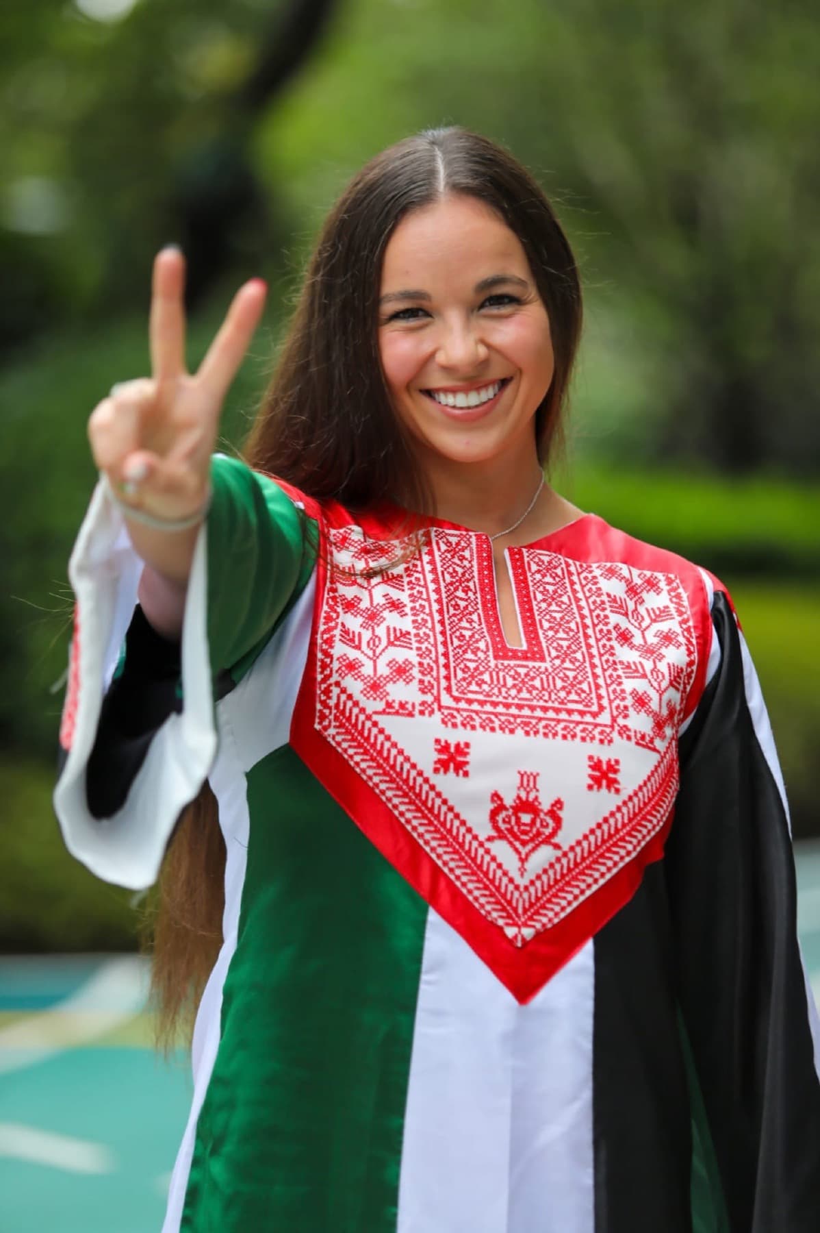 Palestinian athlete in ceremonial dress with embroidered chest panel