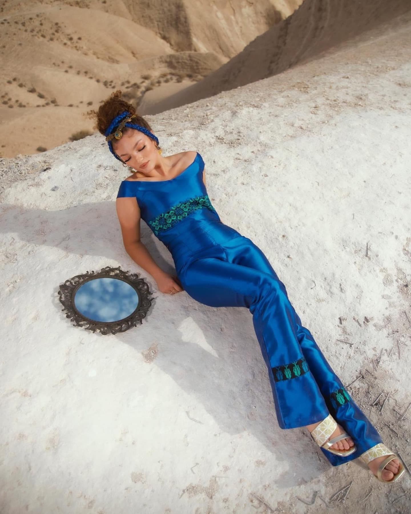Cobalt motif garment reclining in pale desert