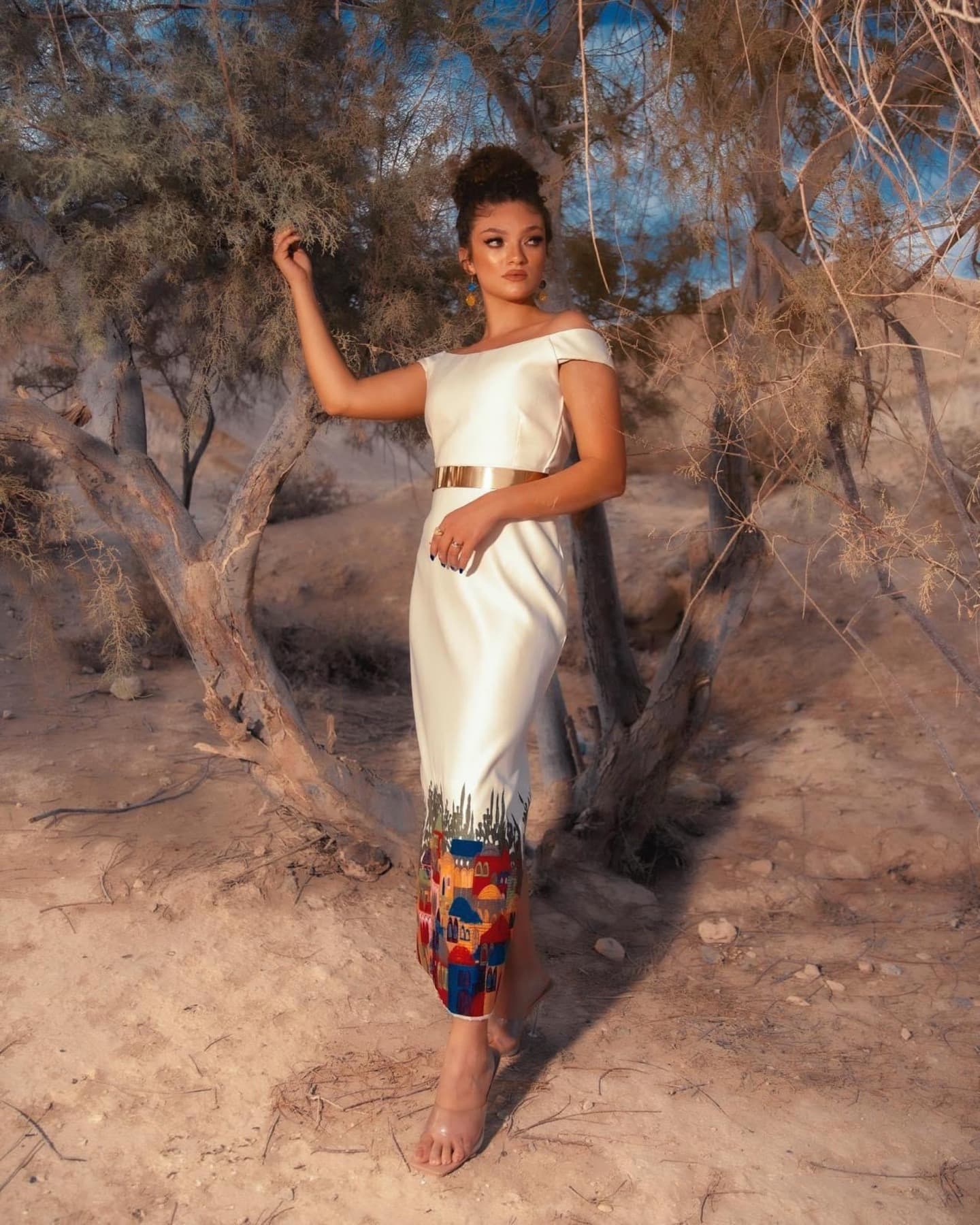 White dress with Palestinian village motif at the hem