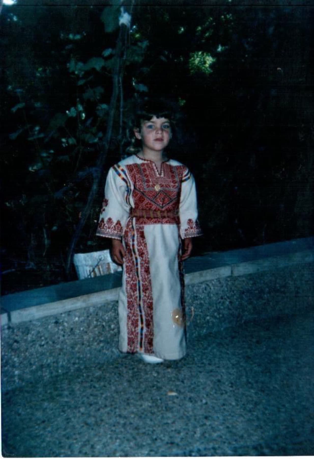 Childhood photograph wearing a Palestinian embroidered dress